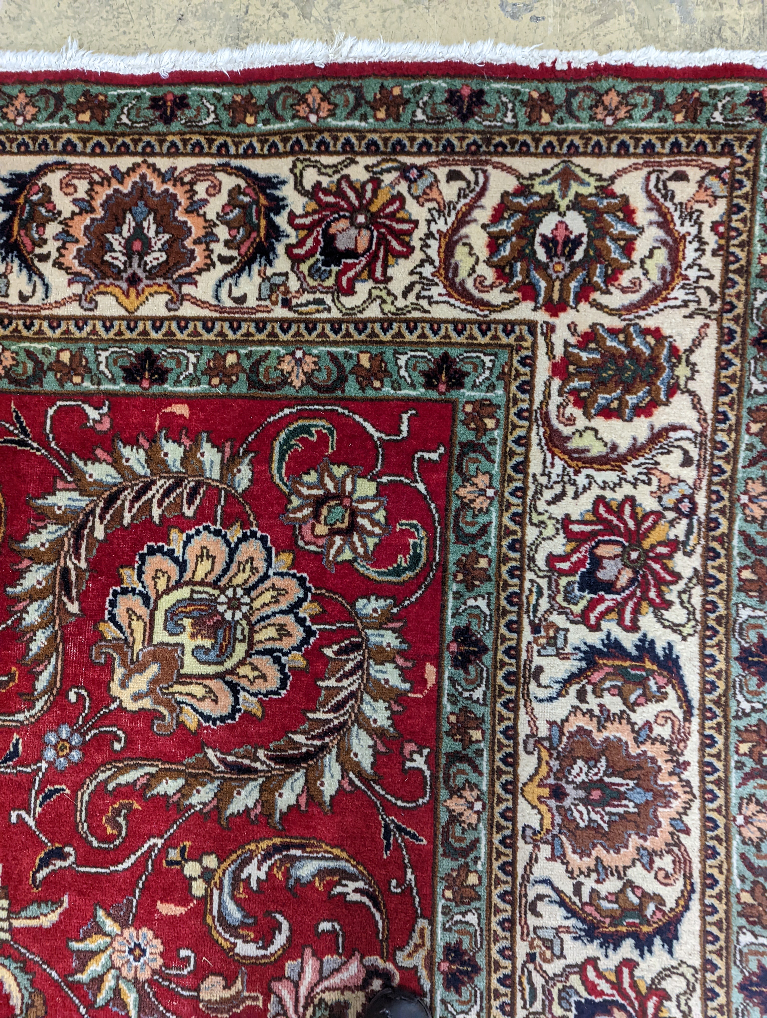 A Tabriz red ground carpet, 400 x 290cm